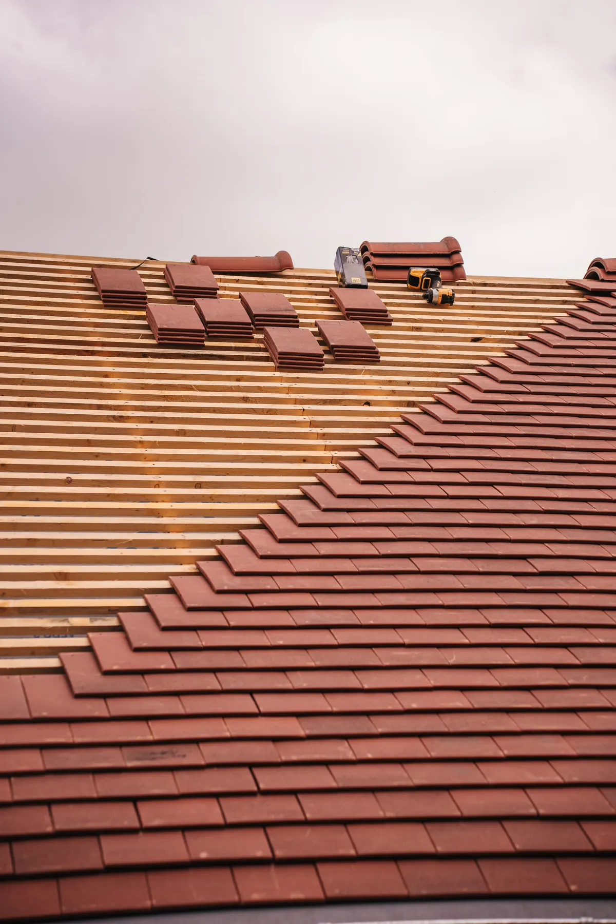 Terracotta tile roof installation in progress